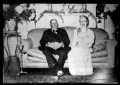 Photograph: [Man and a woman sitting on a couch]