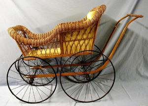 [Wicker Baby carriage, gold fabric-lined interior]