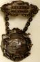Physical Object: [Two pieces medals connected by chain that reads: "MEMBER C.R.A. OF T…