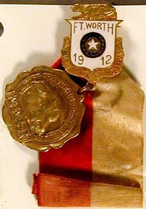 [Gold medal with red and white ribbon]
