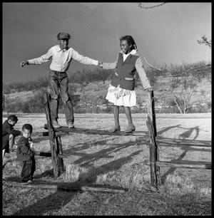 [Bailey Woods and Sue Antoinette Emory Standing on Fence]