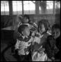 Primary view of [Children Sitting in Cookshack]