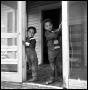 Photograph: [Two Children Standing in a Doorway]