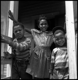 [Three Children at a Porch Doorway]