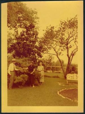 [Three people standing in the George Ranch house yard]