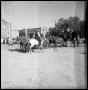 Photograph: [Man on Horse Approaching a Mule Drawn Carriage]