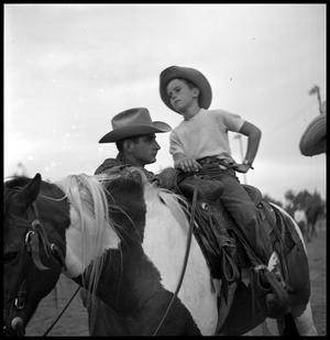 [Boy Atop a Horse with a Man Nearby]