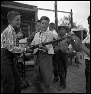 [A Group of Boys Examining a Rifle]