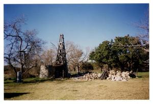 [Photograph of a Windmill and Rock Pile]