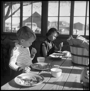 [Boy and Girl Eating at a Table]