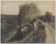 Primary view of [Photograph of a Train Rolling down the Tracks]
