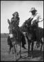 Photograph: [Young Woman and Man Riding Mules]