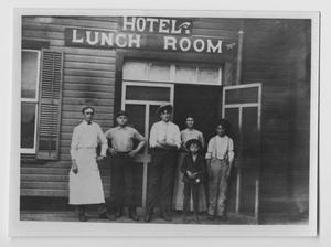 Primary view of object titled '[Photograph of People Outside Hotel Lunch Room]'.