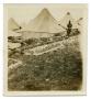 Photograph: [Photograph of Soldier Standing by Tents]