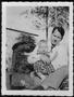 Photograph: [Photograph of a man holding an infant]