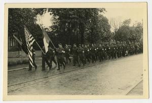 [Photograph of Allied Troops Marching Along a Street]