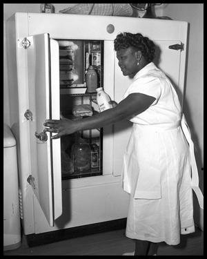 Cook at Governor's Mansion with refrigerator