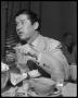 Primary view of [Roy Acuff seated at dining table]