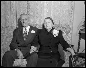 [Elderly Couple Sitting on Couch]