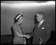 Photograph: [Emma Long and Walter Seaholm shaking hands]