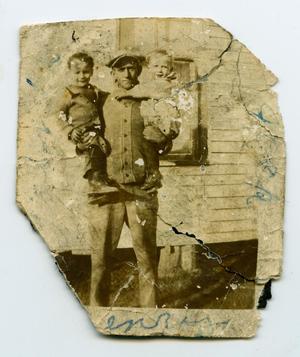[Photograph of James Nelson Holding Two Boys]