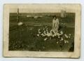 Primary view of [Photograph of a Woman Feeding Chickens]