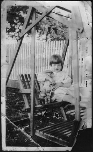 Primary view of object titled '[Photograph of Mary Jones sitting in a wooden swing]'.
