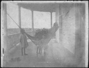 Primary view of object titled '[Photograph of three little girls on the front porch of the J.H.P. Davis House]'.