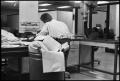 Photograph: [Man Working at Desk at Beaumont Enterprise #4]