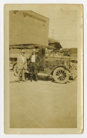 [Two Men in Front of Car and Building]