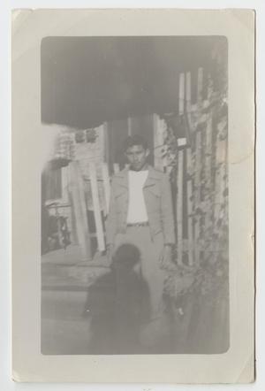 [Photograph of Man Standing in Front of a House]