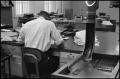 Photograph: [Man Working at Desk at Beaumont Enterprise #11]