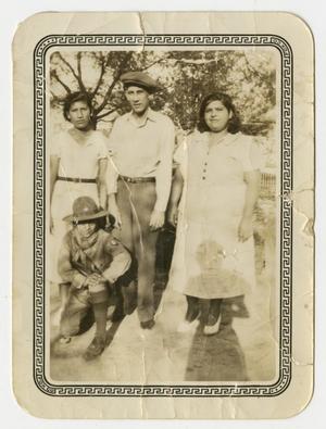 [Photograph of Three Adults and Child Posing Outside]