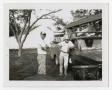 Photograph: [Two Men Standing by Truck in Backyard]