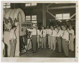 Primary view of object titled '[Group of Men Watching Demonstration of Machine]'.