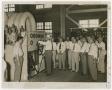 Photograph: [Group of Men Watching Demonstration of Machine]