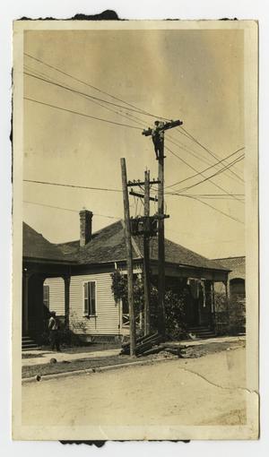 [Utility Poles and Power Lines by Houses]