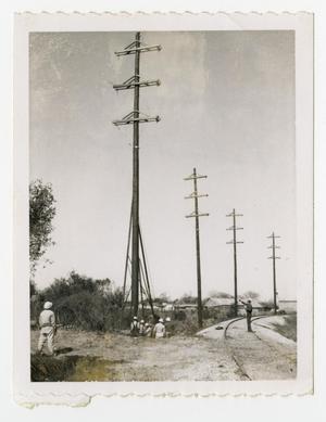 [Utility Poles by Railroad Track]