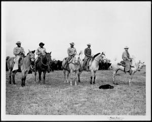 Primary view of object titled '[Photograph of five cowboys on horseback - four of them African-American]'.