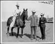 Primary view of [Photograph of Margaret and Lester Goodson standing next to Matlock Rose who is riding the quarter horse]