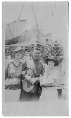 [Photograph of Three Friends by Boat]
