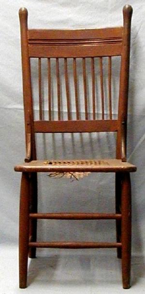 Kitchen chair, nine spindles, plain band. Cane bottom, oak.