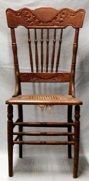 Kitchen chair, pressed design.  Cane bottom, probably oak.