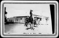 Photograph: [A Man Riding a Bucking Horse]
