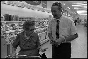 [Photograph of Waggoner Carr and Elderly Woman in Grocery Store]