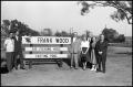 Thumbnail image of item number 1 in: '[Frank Wood and Group Pose Around Fishing Pond Sign]'.