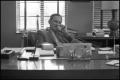 Photograph: [Photograph of Dr. Don Waldrip on Phone Behind Desk]