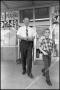 Photograph: [Photograph of Waggoner Carr and Young Boy in Front of Grocery Store]