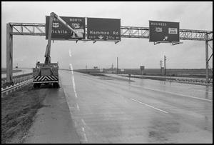 [Workman Installing New Wichita Falls Sign on Highway 287]