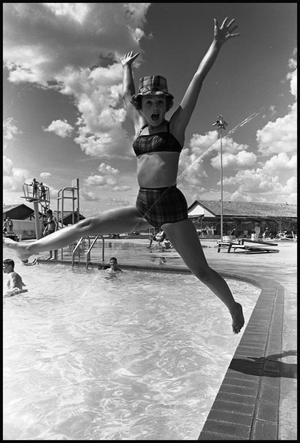 Teenage Girl Jumping Into Swimming Pool